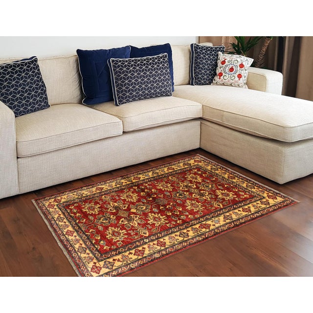 Enhance your home with this exquisite hand-knotted Super Kazak rug, crafted from fine hand-spun wool and dyed with all-...