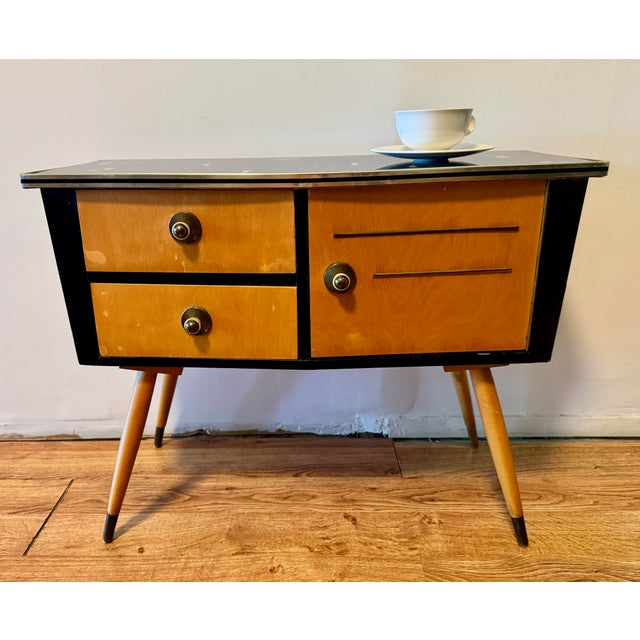 Adorable and very well made Googie-style German low console table with glass top, two drawers and a cabinet. Cute drawer...