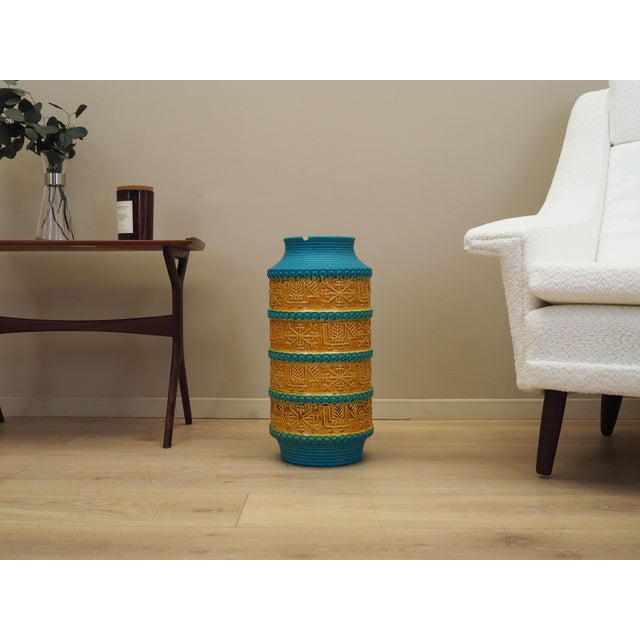 The vase was made in the 1960s, produced by the well-known German manufactory Bay Keramik. It is made of ceramic in yellow...