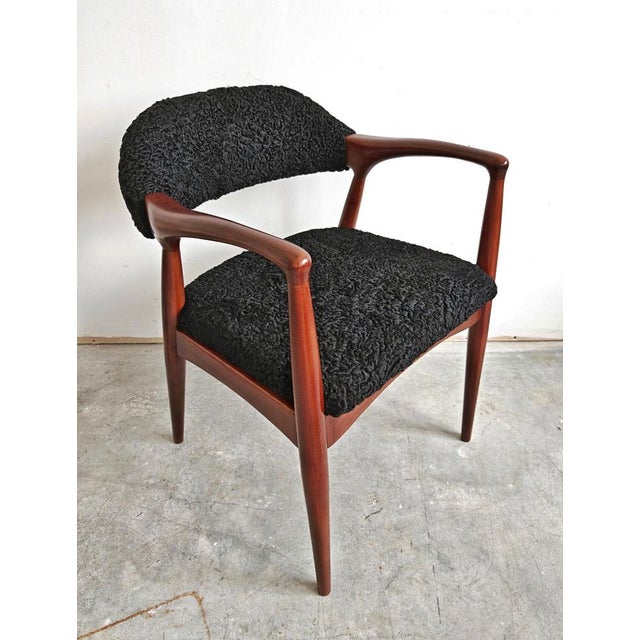 A sleek and exceptionally stylish Mid Century Modern armchair done in beech and upholstered in astrakhan, combining...