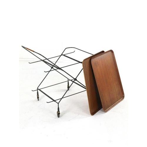 Very handy and nice, stylish vintage serving trolley. The frame is made of black lacquered metal and stands on wheels; the...