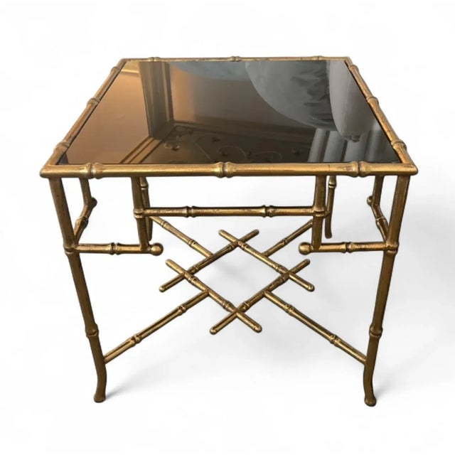 Elevate your living space with this striking vintage side table, a classic piece of Hollywood Regency design. The table...