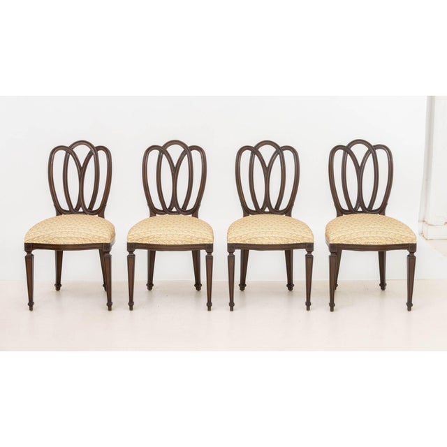 Set of Twelve American Hepplewhite Style Mahogany Dining Chairs, each with reticulated ribbon form back and upholstered...