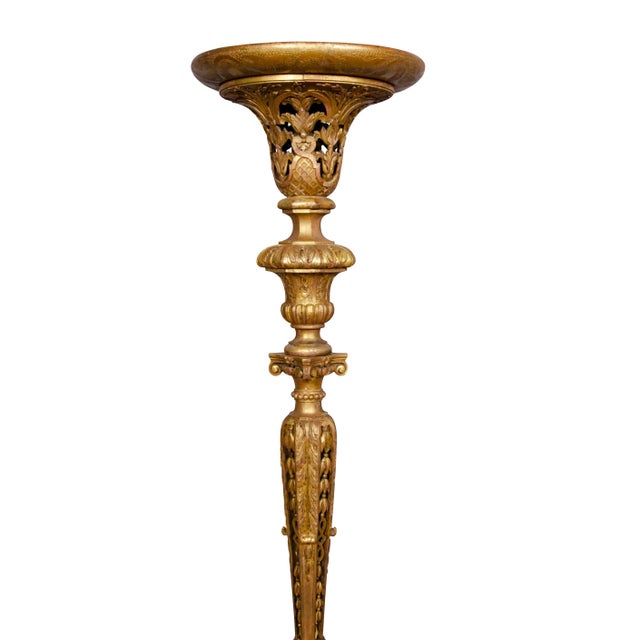 With dished circular tops with a carved and pierced support ending on three carved legs.