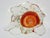 Handmade glass ashtray with a clear glass base and orange center. It features a Sommerso technique, where layers of...