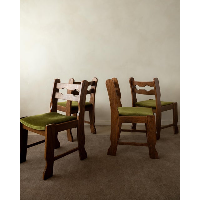 A vintage set of 4 brutalist oak razorback dining chairs with green velvet upholstery, made by an unknown european maker...