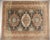 Triple geometric medallions on a blue ground surrounded by nomadic motifs. Multi border with the main border in ivory,...
