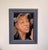 This oil on panel artwork captures a dynamic moment, depicting a woman with expressive features and flowing hair,...