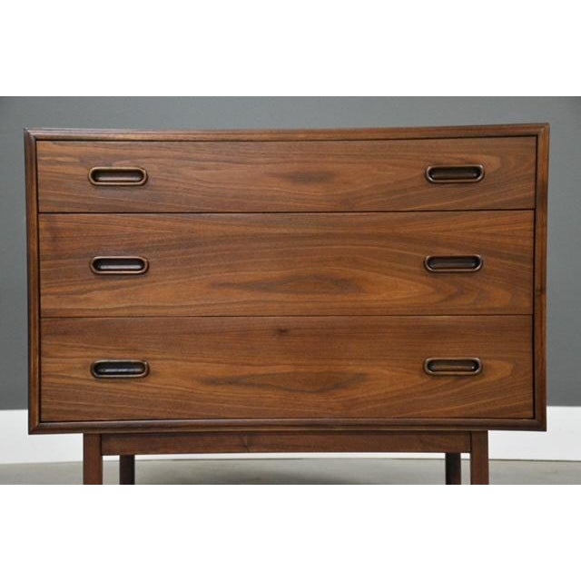A beautiful mid century modern walnut three drawer dresser chest designed by Jack Cartwright for Founders. Professionally...