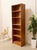 A handsome vintage Danish Modern bookcase crafted in warm teak with a beautifully streamlined, architectural profile. The...