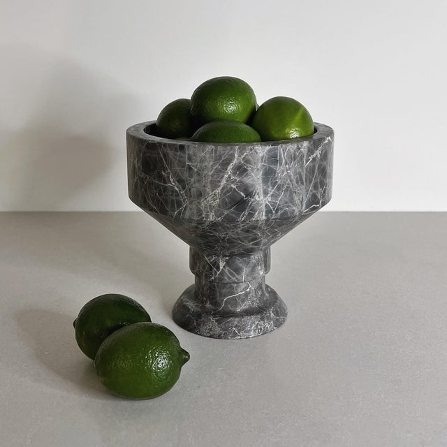 Handcrafted from richly veined grey marble, the Tasse Bowl is defined by its elevated pedestal form and strong geometric...