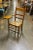 A circa 1930s wooden school chair with a caned seat and attached writing desk, showcasing vintage charm and functional...