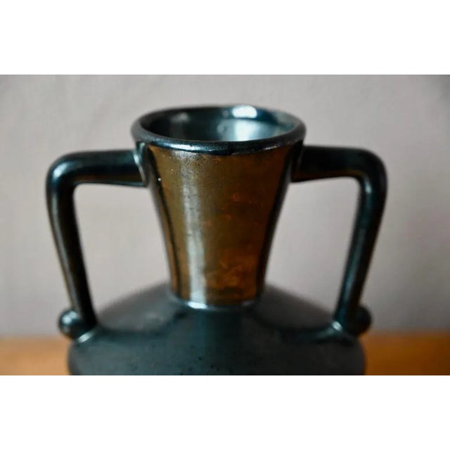 This pretty vase, with its classic shape and glossy black glaze, is a product of the Poët Laval workshops in the Drôme...