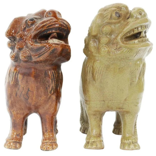 Pair of Vintage Chinese Ceramic Foo Lion Guardian Sculptures with Incense Holders A striking pair of vintage Chinese...