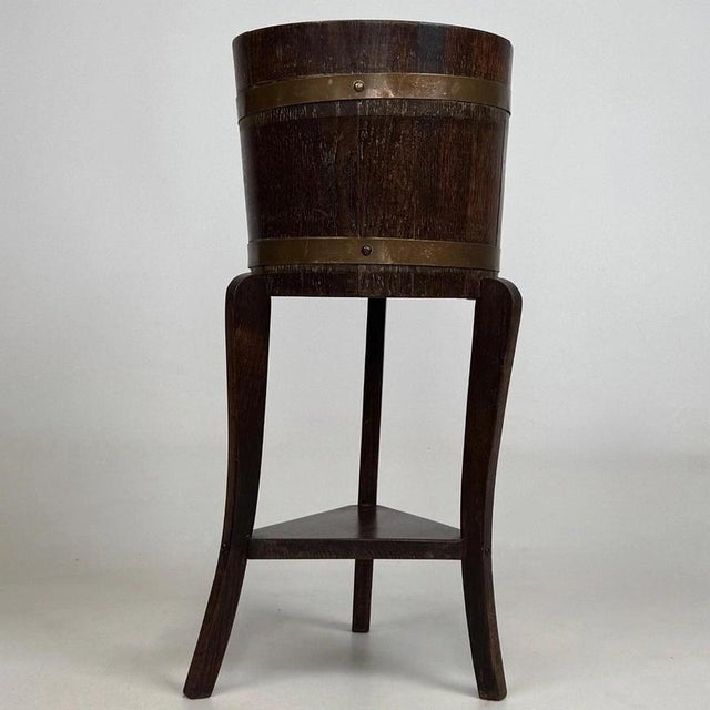 A charming and highly distinctive early 20th-century oak barrel-form plant stand by r.a. Lister & co., beautifully...