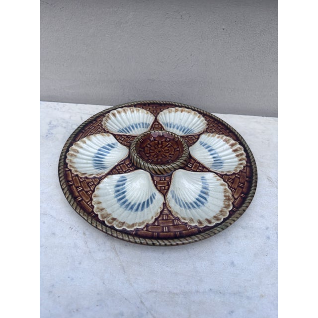 Rare yellow Majolica oyster plate, six white wells on a yellow basket weave, circa 1890 signed Longchamp.