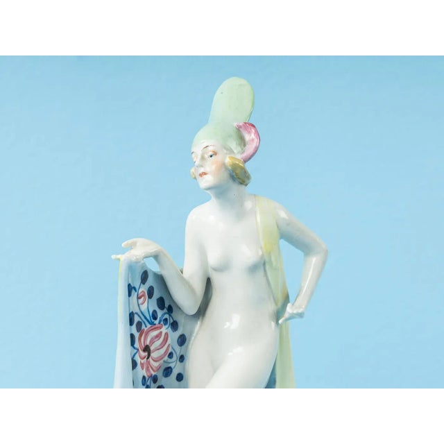 Art Deco character from the 1920s. Decorative porcelain dancer with a hand-painted cape and hat typical of the time....