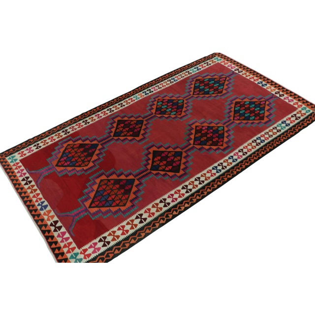 Originating from Turkey circa 1950-1960, a mid-century kilim rug. Featuring a well defined traditional pattern in vivid...
