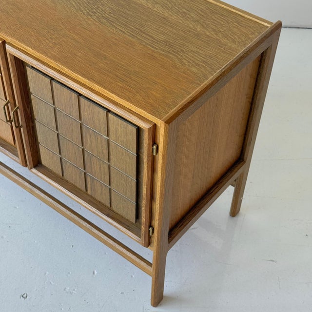 c. 1980s. Denmark. Brass pulls and full wood construction with two tone stained doors.