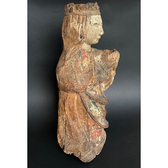 Religious wooden statue carved from a single block of wood, dating from the Middle Ages. An antique piece of folk...
