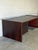 This executive desk commands attention with its substantial slab-sided form and expansive workspace. The asymmetrical...
