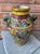 This vintage Italian Majolica terracotta urn (or vase) showcases vibrant, hand-painted designs and distinctive lion head...