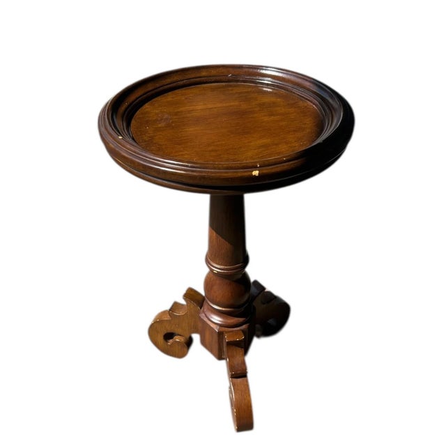 Charming small taboret table crafted from solid wood. This piece features a round top with a raised edge, supported by a...