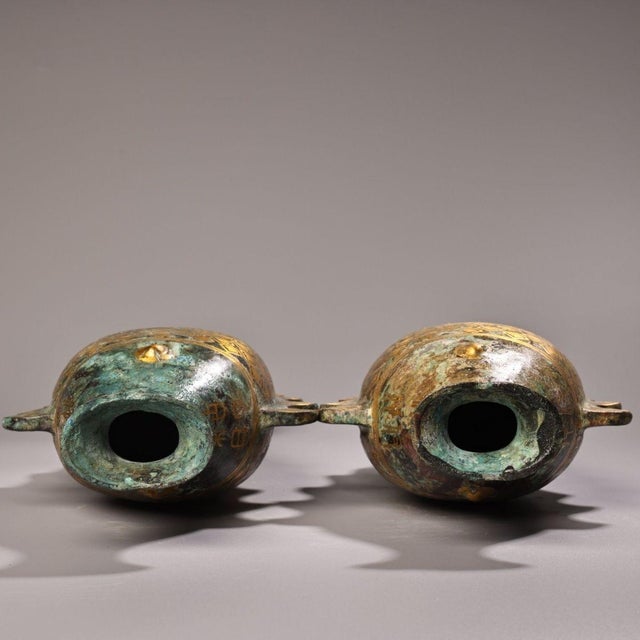 Add a touch of ancient symbolism and metallic elegance to your home with this exceptional pair of vintage Chinese bronze...