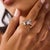 This exceptional Mid Century diamond ring is a sophisticated 1950’s design, centered by a GIA-certified emerald cut...