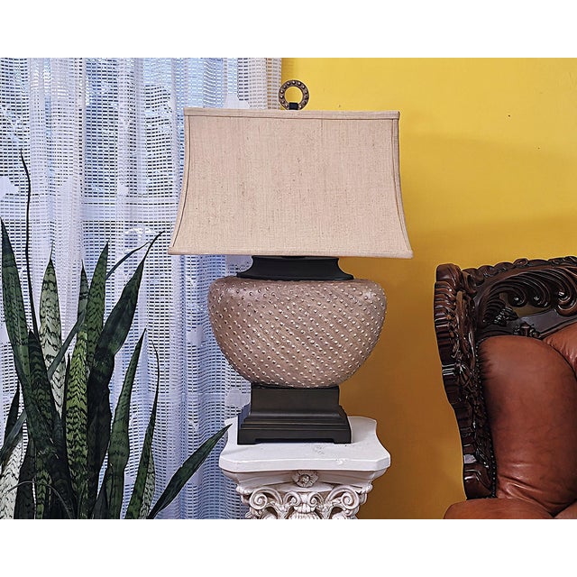 Uttermost Cumberland table lamp featuring a substantial textured body in warm sandstone/taupe with raised pebble-bead...