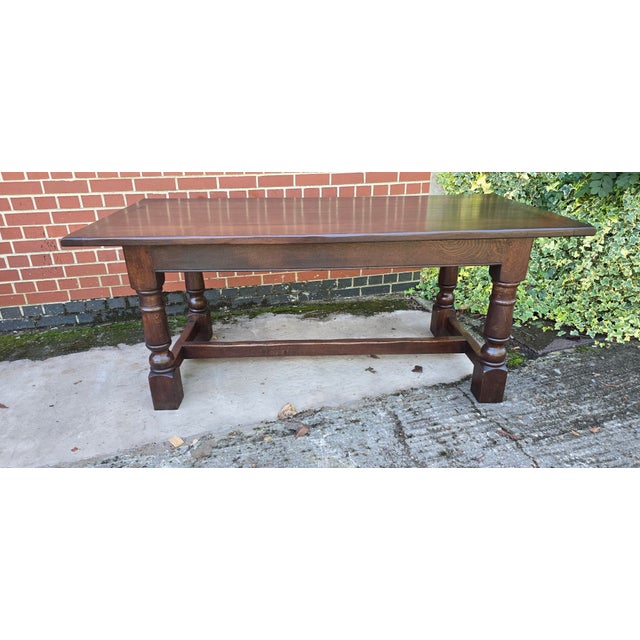 Super dark oak plank and cleated oak refrectory farmhouse table on turned legs with H stretcher, in very good overall...