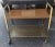 A Mid-Century Brass and Formica top Rolling Cart. Measures 25" in width, 13.5" in depth and stands 25" tall. Lower tier is...