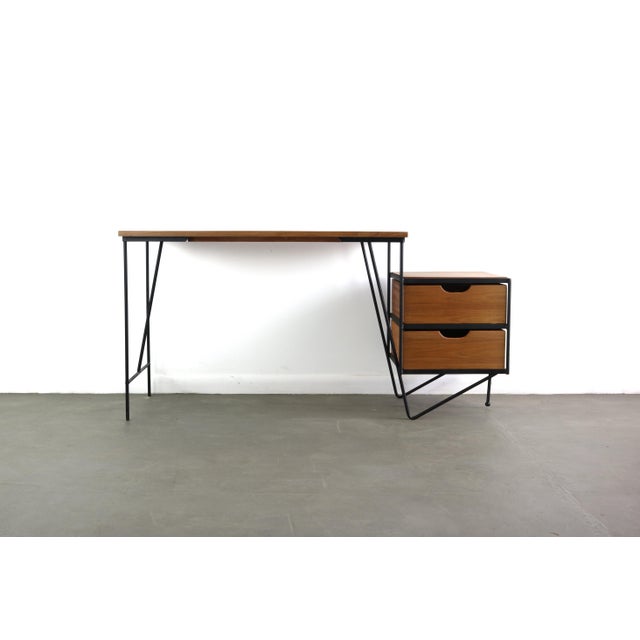 Modernist desk of walnut and wrought iron, with floating bank of drawers. Designed by D.R. Bates and Jackson Gregory for...