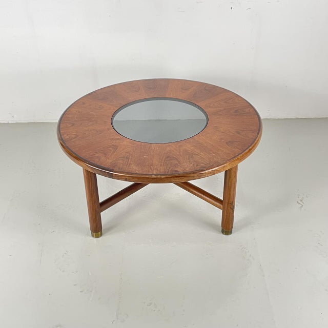 Lovely MidCentury vintage teak round coffee table with afromosia legs and smoked glass top. Brass fixings and feet. In...
