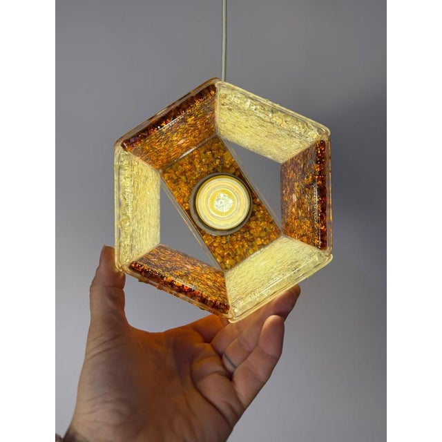 A captivating lighting fixture from Sweden: This distinctive pendant lamp by Roland Konst brings the warm, textured charm...