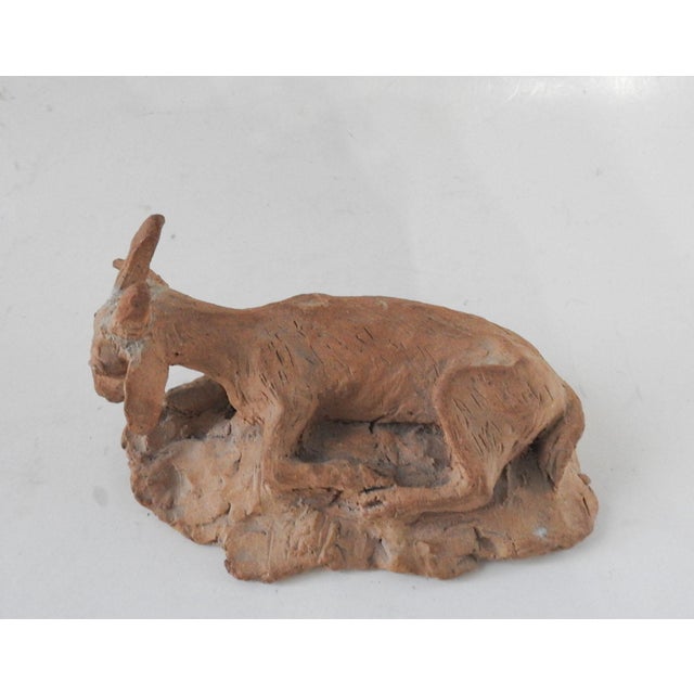 Mid 20th century terracotta clay sculpture of a goat. Unsigned, horns look to have been repaired.