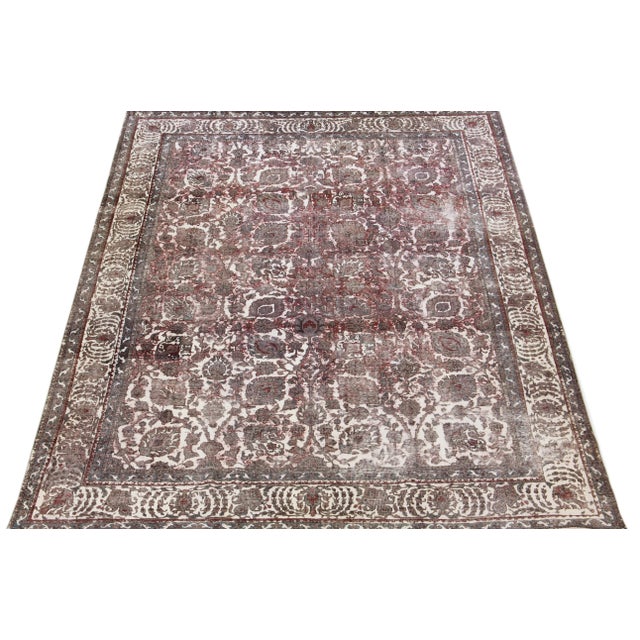 This vintage Persian wool rug features exquisite hand-knotted craftsmanship and boasts a stunning color palette of red and...