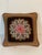 Beautiful handmade needlepoint central rosette on chocolate brown background, decorated with multicolored rope trim and...