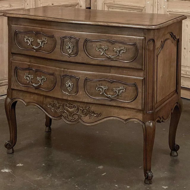Antique Country French Regence Walnut Commode was hand-crafted from the premier indigenous hardwood of Europe, sumptuous...