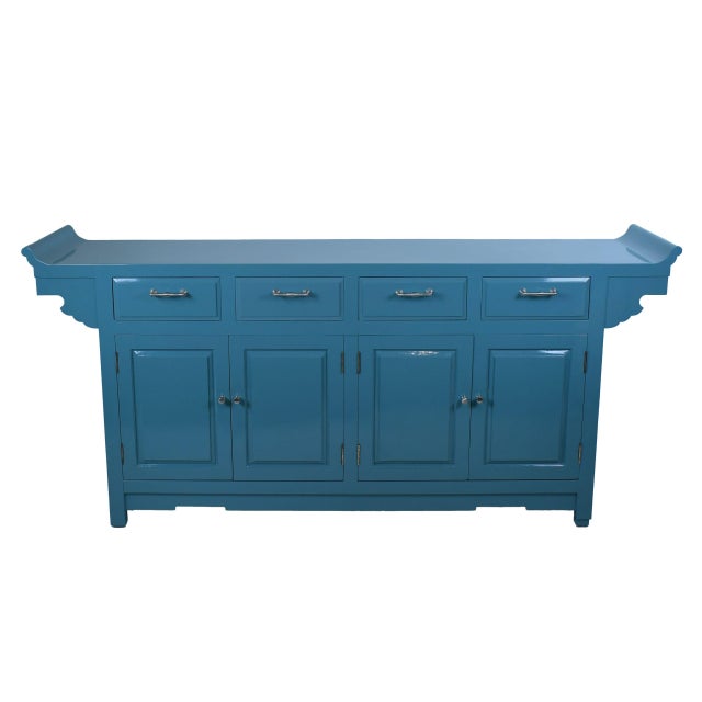 A large Ming-style credenza stretching over six feet, with clean architectural lines and fretwork-inspired detailing. The...