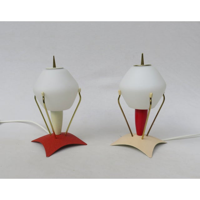 A pair of rare small lamps, "Rocket" bedside lamps, made in Germany in the 1950s. The two lamps differ in color but are...