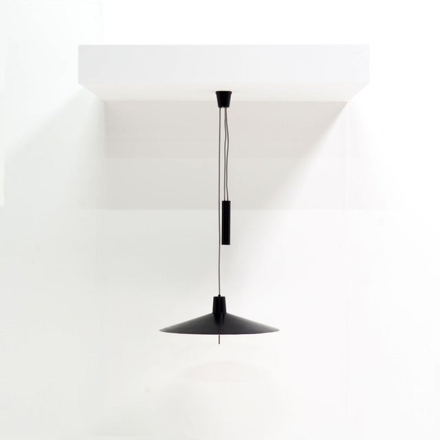 Rare, height-adjustable black metal lamp from the 1950s with a very sleek and modern architecture. Up to 250V (Europe/UK...