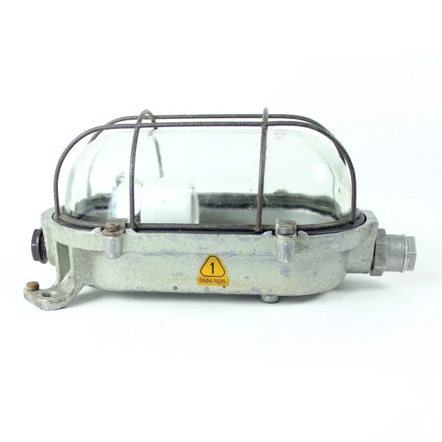 Great vintage industrial wall light produced in Czechoslovakia in 1950s. the light is made of steel base with a strong...