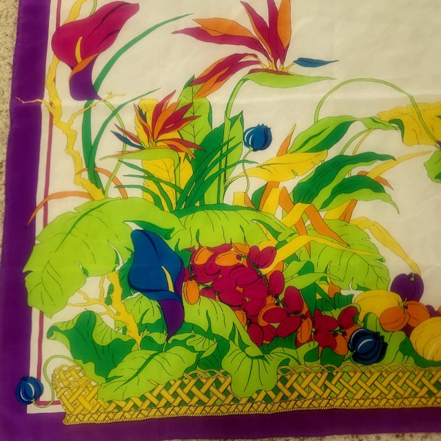 Jean Patou silk scarf, vintage 1970s, framed by a royal purple border, ivory ground with vibrant tropical foliage above a...