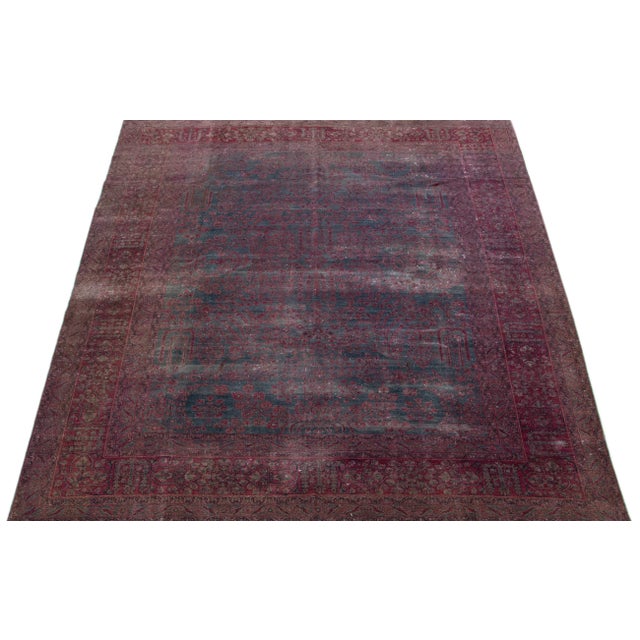 Beautiful antique Persian distressed hand-knotted wool rug with a gray color field. This piece has red accents in a...