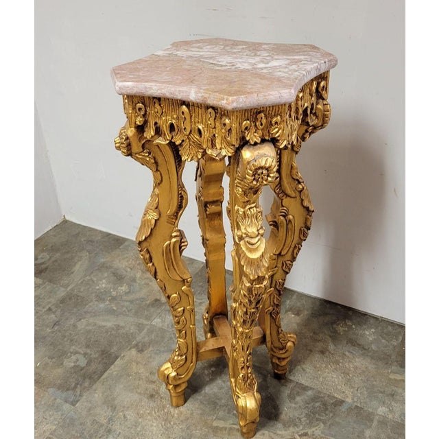 Late 20th C Italian accent table or pedestal with carved antiqued gold leaf base and a removable marble top. Surprisingly...