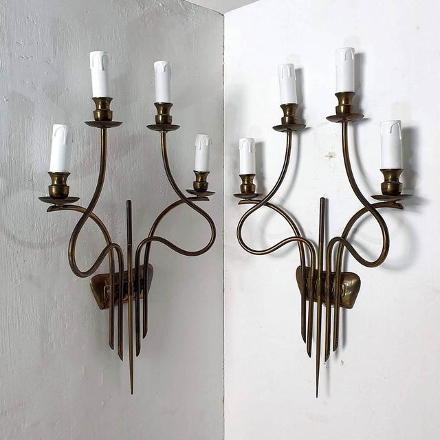 An unusual pair of large mid-century brass sconces or wall lights by Guglielmo Ulrich, circa 1940's, Italy. The brass has...