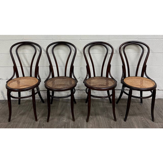 This is a beautiful set of four antique Thonet style bentwood dining chairs with hand-caned seats, dating to the early...