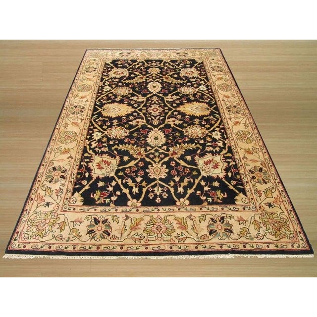 This hand knotted pile rug features a primary brown earth tone palette and is crafted from a premium blend of wool and...