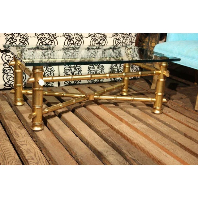 Nice large-scale carved wood gilt faux bamboo coffee table with a new glass top. Perfect for a Hollywood Regency style home.
